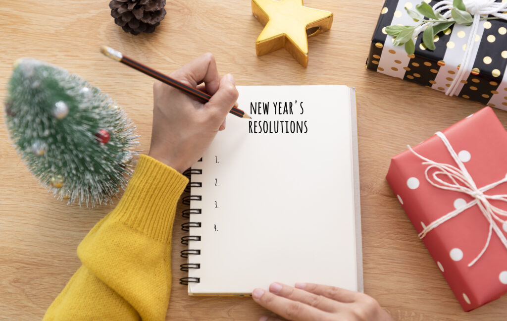 woman hand writing new years resolution note paper new year day